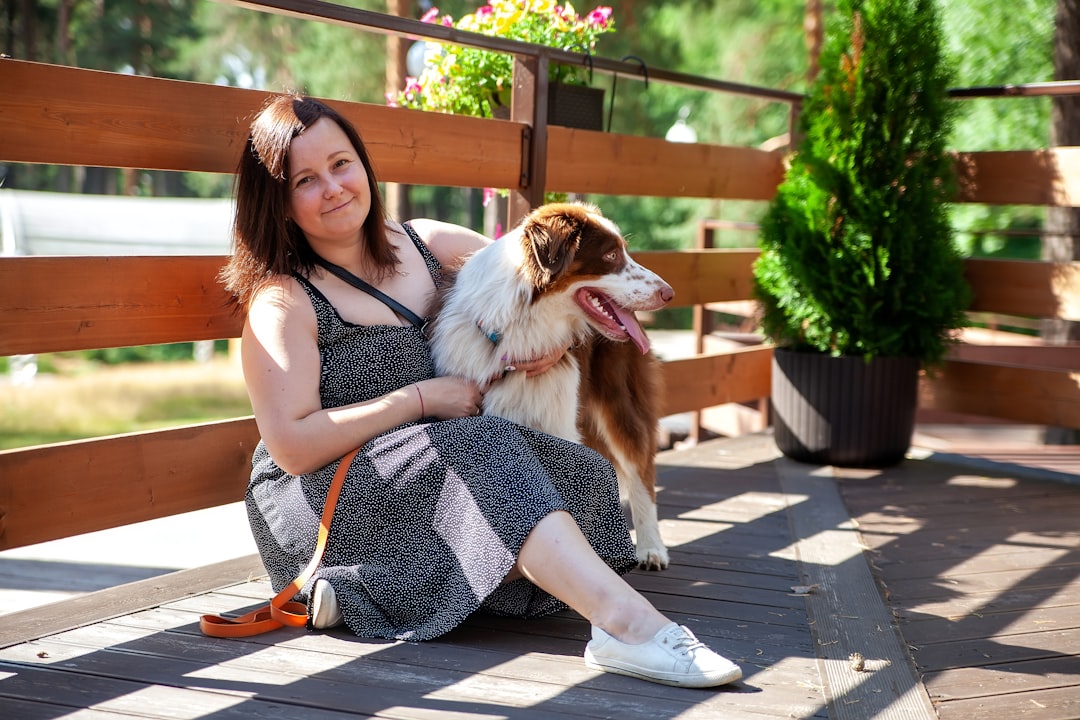 a woman sitting on a bench with a dog